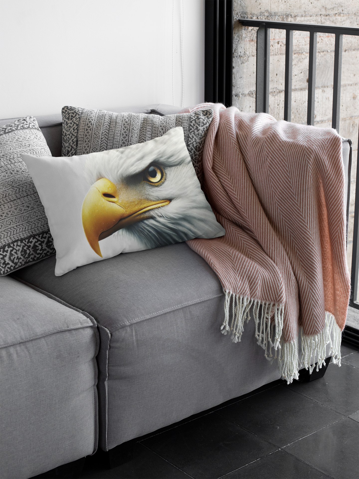 Comfortable grey couch with a throw pillow depicting a bald eagle’s sharp yellow beak and fierce expression, paired with neutral tones for a modern touch.